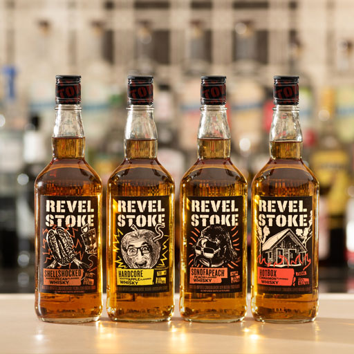 Four bottles of different flavored Revel Stoke whisky on a bar