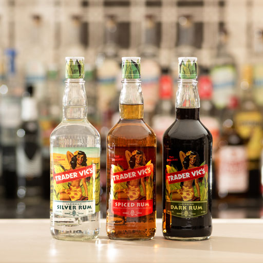 Three bottles of Trader Vics rum on a bar