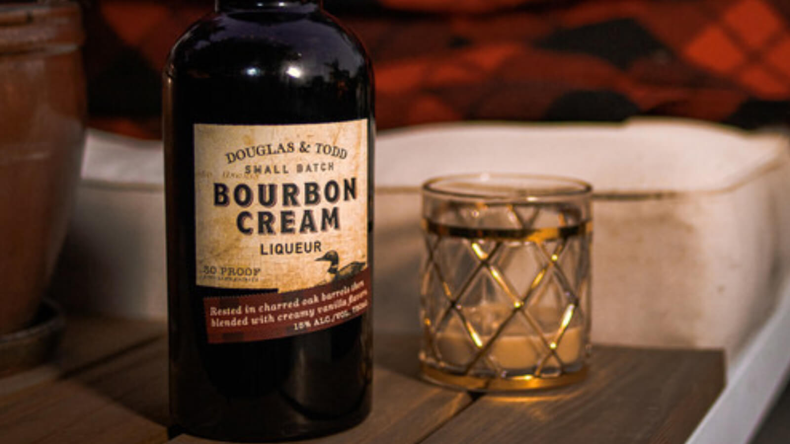 A bottle of Douglas & Todd bourbon cream with a glass