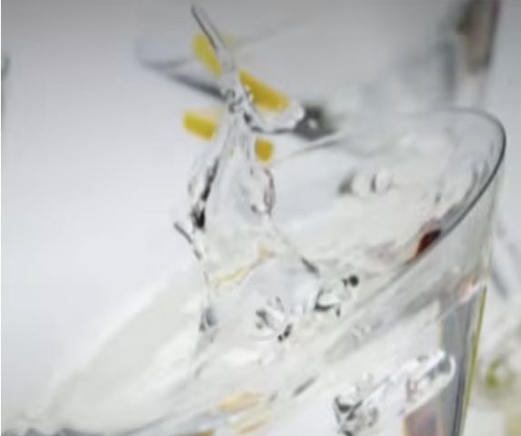 close up of a martini splashing in the air